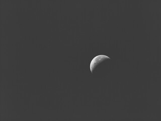 Black and white image of a crescent moon shines in the sky © Cam