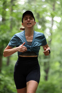 Athletic Woman Running on Forest Trail