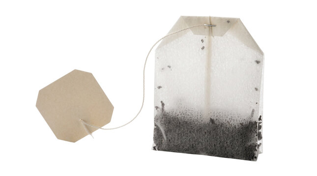 Used tea bag with label on string for hot beverage preparation on transparent background.