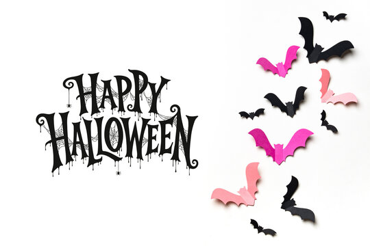 Happy Halloween lettering surrounded by black and pink flying bats on a white background, ideal for greeting cards, party invitations, posters, stickers and seasonal advertising.