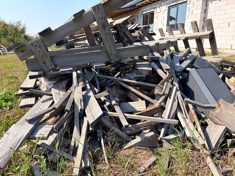 a large pile of wooden construction debris in the backyard of the construction site