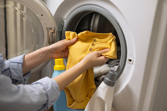 Washing baby clothes in washing machine at home