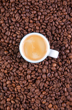 Espresso against a background of coffee beans