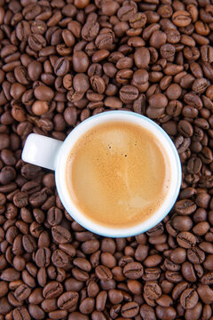Espresso against a background of coffee beans