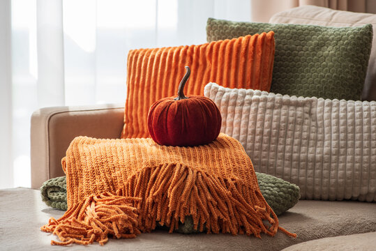 Cozy Autumn Home Decor Arrangement With Velvet Pumpkin And Textured Throws On Sofa