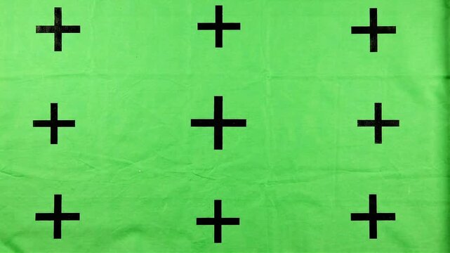 Green screen backdrop with tracking markers for motion graphics and visual effects