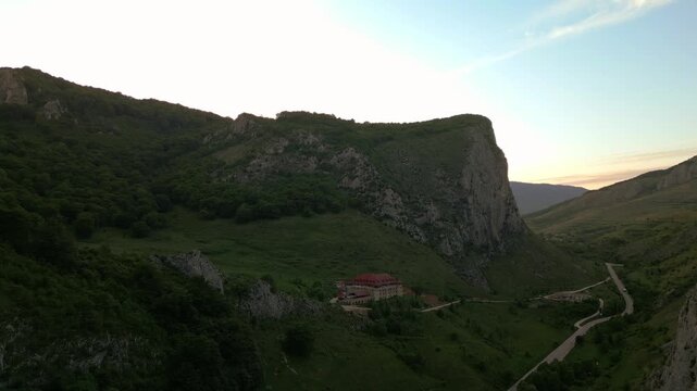 Building in a mountain valley during dusk