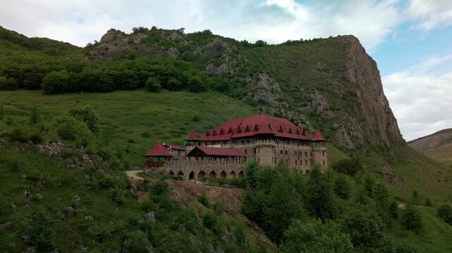 Templul cavalerilor castle stands on a green hill overlooking the trascau mountains