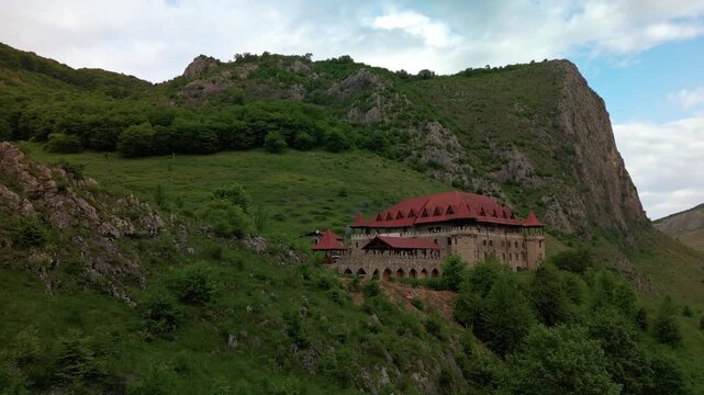 Templul cavalerilor castle stands on a green hill overlooking the trascau mountains