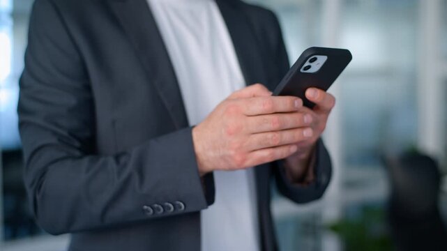Cropped view unrecognizable business man scrolling mobile phone application work pause break in office male businessman manager using smartphone technology watching online video chatting in company