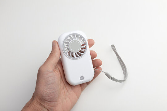 Hand Holding White Portable Mini Fan with Lanyard on White Background
