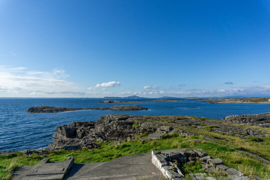Fj&oslash;l&oslash;y island coastline with rocky shores and blue sea
