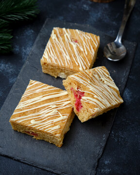 Blondie bars with white chocolate drizzle and cranberry pieces