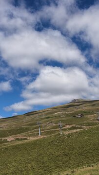 Summer Alpine Landscape with Ski Lift Infrastructure on Green Hills
