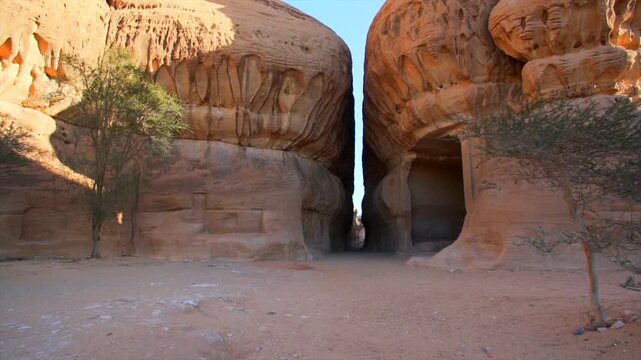 Majestic cinematic view of the ancient Nabataean Al-Diwan chamber carved into sandstone rocks at Jabal Ithlib in Hegra, AlUla