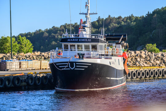 Lindesnes, Norway - June 16 2026: Small workboat moored head on at quiet coastal harbor.