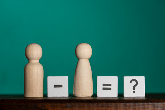 Relationship concept with wooden figures and mathematical signs. Wood peg dolls and math symbols puzzle representing divorce separation family problem, partnership break up and conflict concept