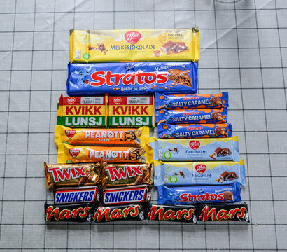 Lindesnes, Norway - June 17 2026: Assorted Scandinavian chocolate bars arranged on checkered tablecloth.