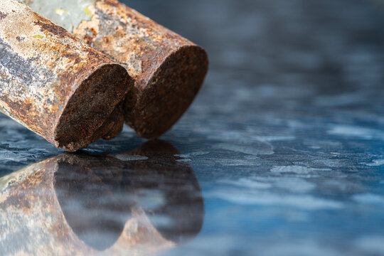 Cross section of a rusted steel rods in an industrial setting, corrosion, raw metal texture steel
