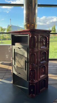 Traditional ceramic stove with chimney in modern interior setting