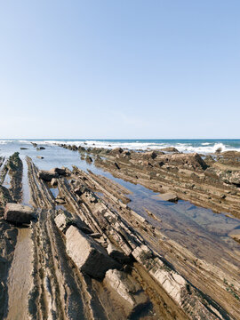 Eye-level view of the unique Flysch rock layers on the tidal platform in Zumaia, Spain