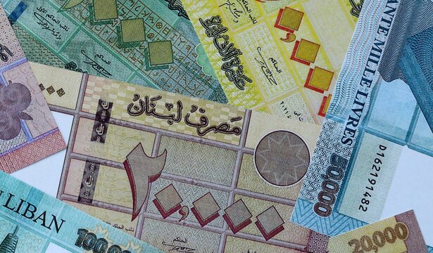 Lebanese pound money bills in pile on table. Lebanon LBP currency cash close up