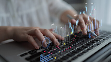 A professional environment featuring a person typing on a laptop with exciting financial data...