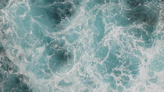 Atlantic Ocean surface covered with dense sea foam. Turbulent water and breaking waves fill frame