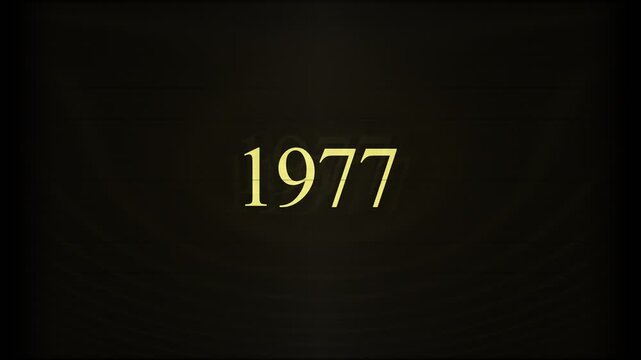 The year 1977 appears in yellow pixelated text, with a blinking cursor, on a computer screen. Evokes vintage computing and historical technology themes for documentaries or presentations.