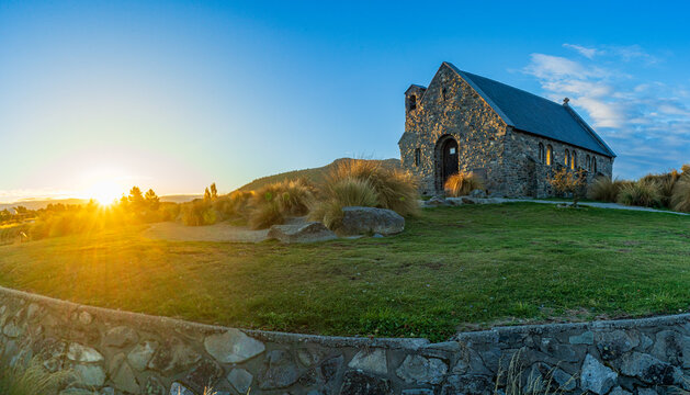 Panoramic sunset behind the historic stone Church of the Good Shepherd, Lake Tekapo