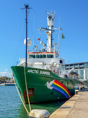 Obraz premium Burgas, Bulgaria - September 07, 2026: Full view of Greenpeace Arctic Sunrise, Burgas port. Greenpeace research vessel from bow, showing green hull, bridge, masts, radar equipment, rainbow dove emblem