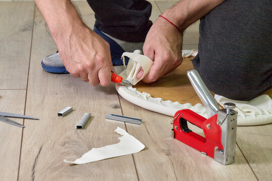 Indoor installation work: staple gun, fabric, wooden base, wooden floor 