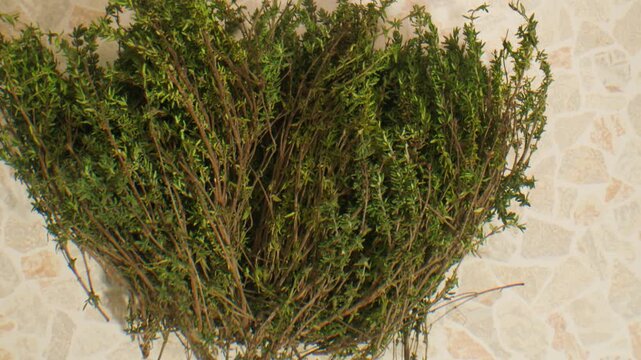 Green thyme bunch tied together, aromatic spices of dried thyme for use in cooking and folk medicine, herbal tea, kitchen. 