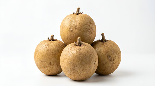 Four ripe round brown sapodilla fruits with rough fuzzy texture stacked pyramid with small dry stem on top, dull skin black spots, sweet tropical fruit, clean white minimalist background