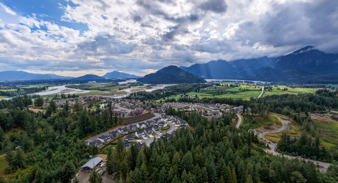 Aerial View of Suburban Neighborhood and River Valley With Mountains in Fraser Valley, BC