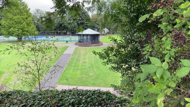 Park Bandstand and Tennis Courts Seen Through Trees, Static Shot