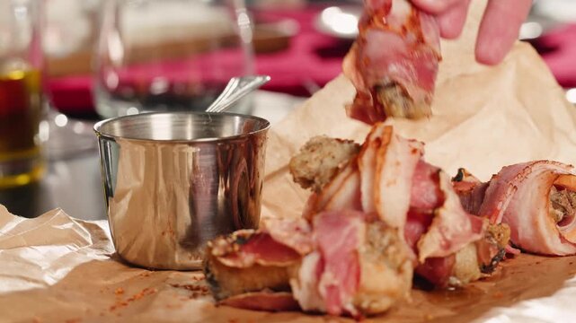 Fried bacon roll served in a beer pub restaurant, close up of crispy grilled bacon snack, tasty meat appetizer for beer in a cozy gastropub.