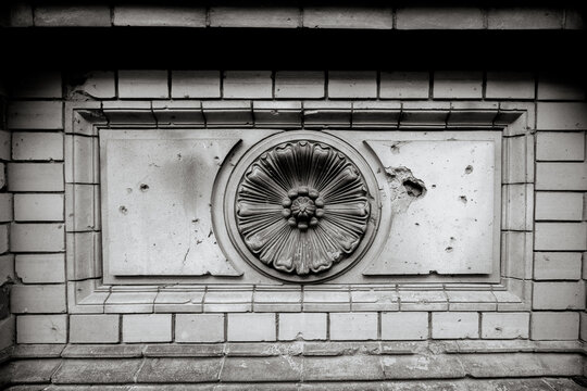 Berlin, Germany - July 5, 2026: Black and white architectural detail shows a circular ornamental rosette set into the masonry of a historic Berlin bridge.