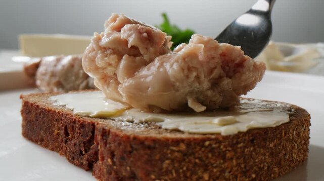 Cod liver superfood can, omega 3 Smoked cod liver in oil in open tin can with fresh greens on wooden table. Seafoods delicacy