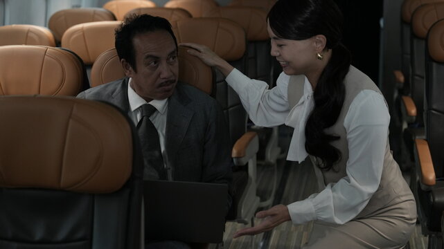 Flight attendants are serving passengers and providing in-flight safety instructions.