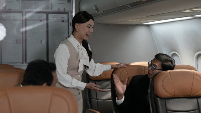 Flight attendants are serving passengers and providing in-flight safety instructions.