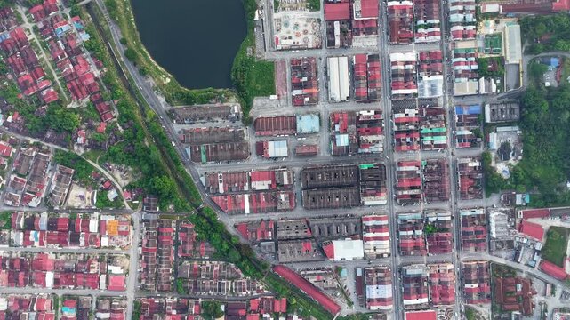 Overhead view of a dense urban neighborhood. Red roofed buildings line organized streets at Kampar