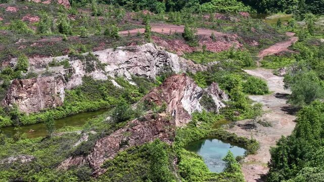 Aerial view captures a rugged, green landscape with deep, winding ravines