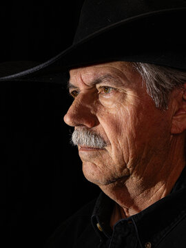 Cowboy Portrait Color. Color portrait of a cowboy wearing a black cowboy hat looking to the left.