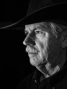 Cowboy Portrait Black & White. Portrait of a cowboy wearing a black cowboy hat looking to the left.