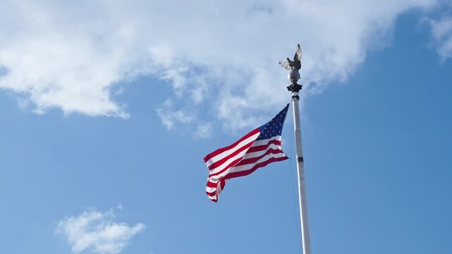 4th of July. American flag waving in the wind. Flag of the USA. National waving flag of united states on blue sky. Independence day. Patriotic symbol. 4k footage. American flag in Washington DC