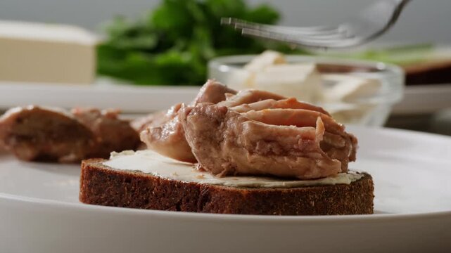 Cod liver superfood can, omega 3 Smoked cod liver in oil in open tin can with fresh greens on wooden table. Seafoods delicacy