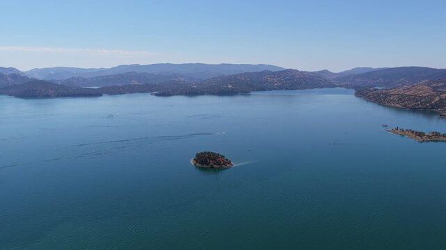Very High Wide Aerial of a Small Island Lost in Open Blue Water
