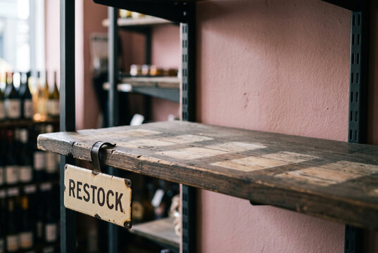 Retail Restock Shelf with Empty Display and Sign