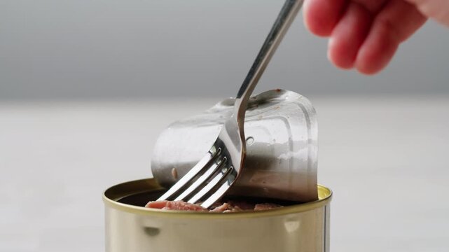 Cod liver superfood can, omega 3 Smoked cod liver in oil in open tin can with fresh greens on wooden table. Seafoods delicacy